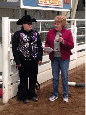 Helping others has been the life work of Karen Russell as she presents a scholarship to one of literally thousands and thousands she’s helped from the classroom to the show pen.